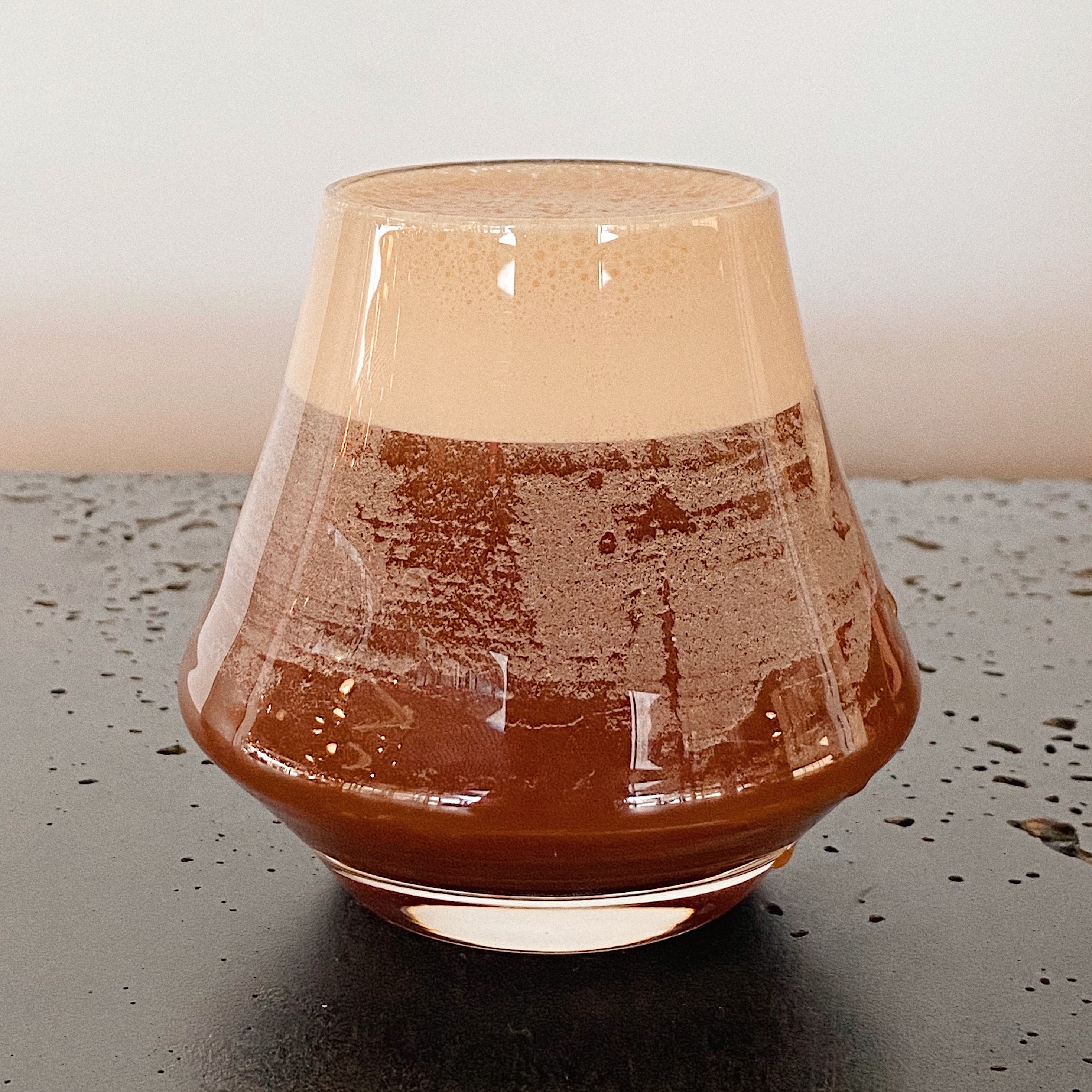 Coffee in glass with white backdrop